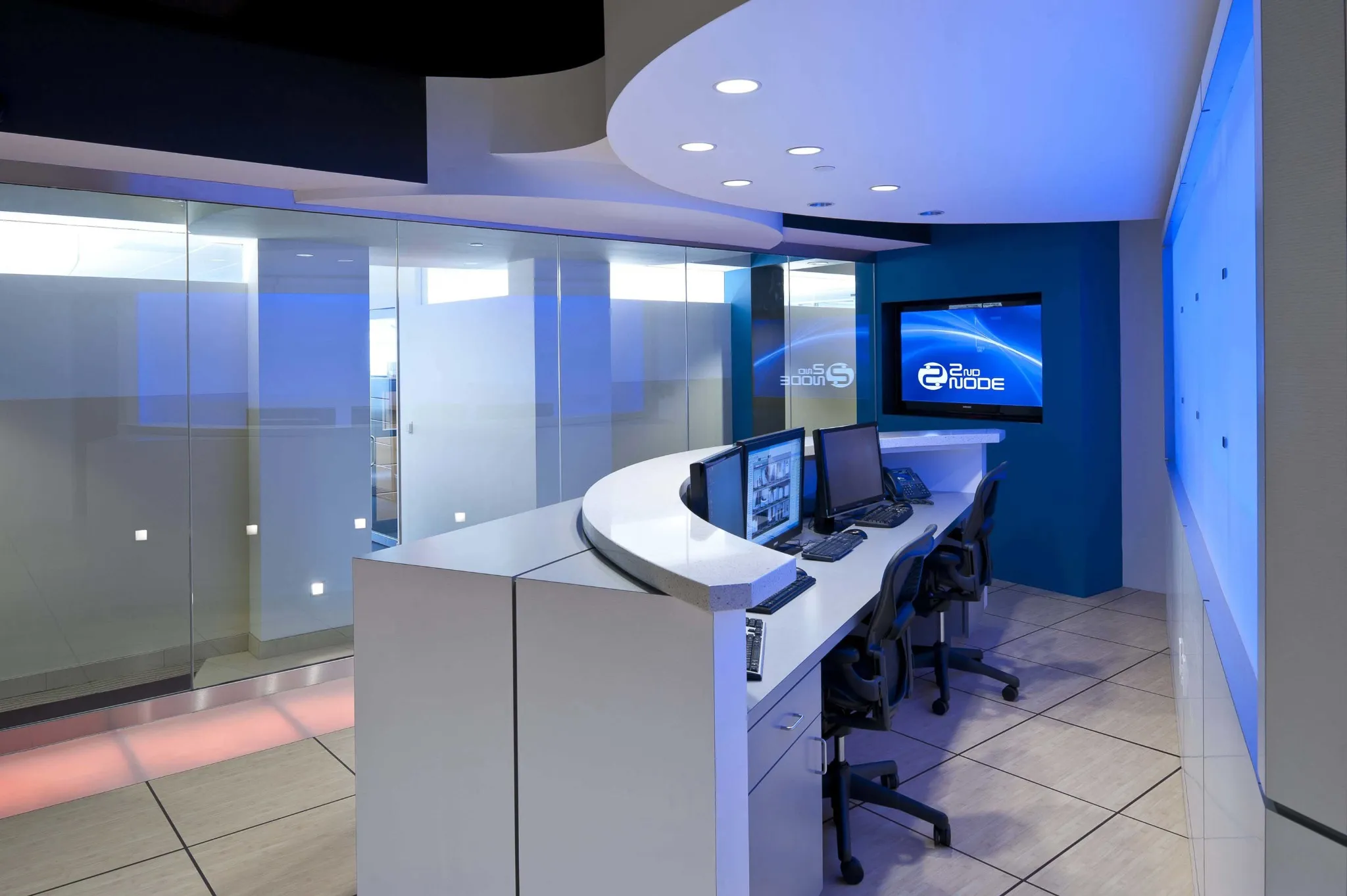 2nd node lobby with glass doors and a desk with blue lights